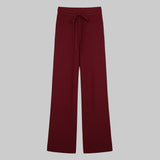 Maroon wide-leg pants with a tie waist on a white background