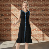 Woman wearing a black dress with blue accents on a gray background