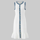 White dress with blue trim and buttons on a gray background