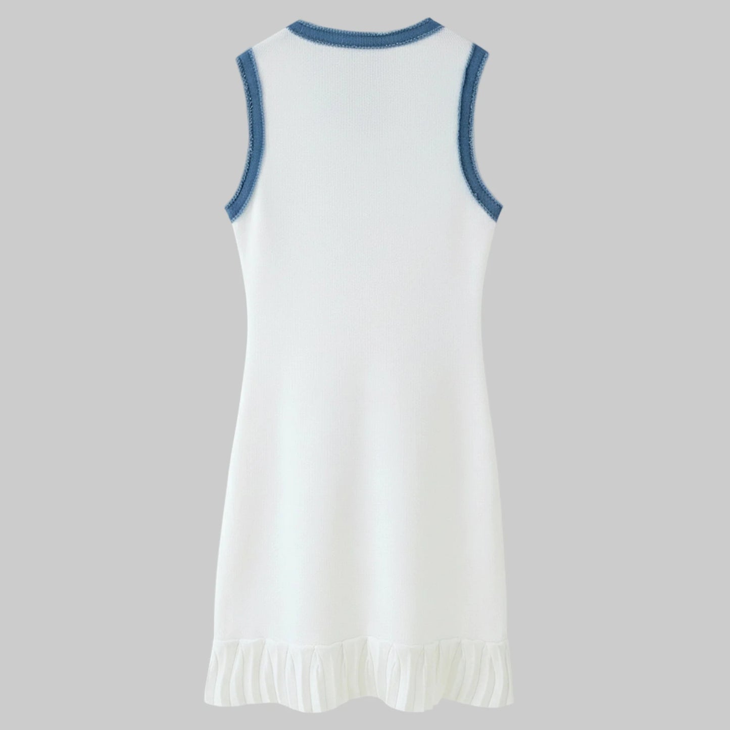 White dress with blue trim on a gray background