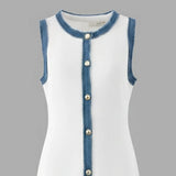 White dress with blue denim trim and buttons on a gray background
