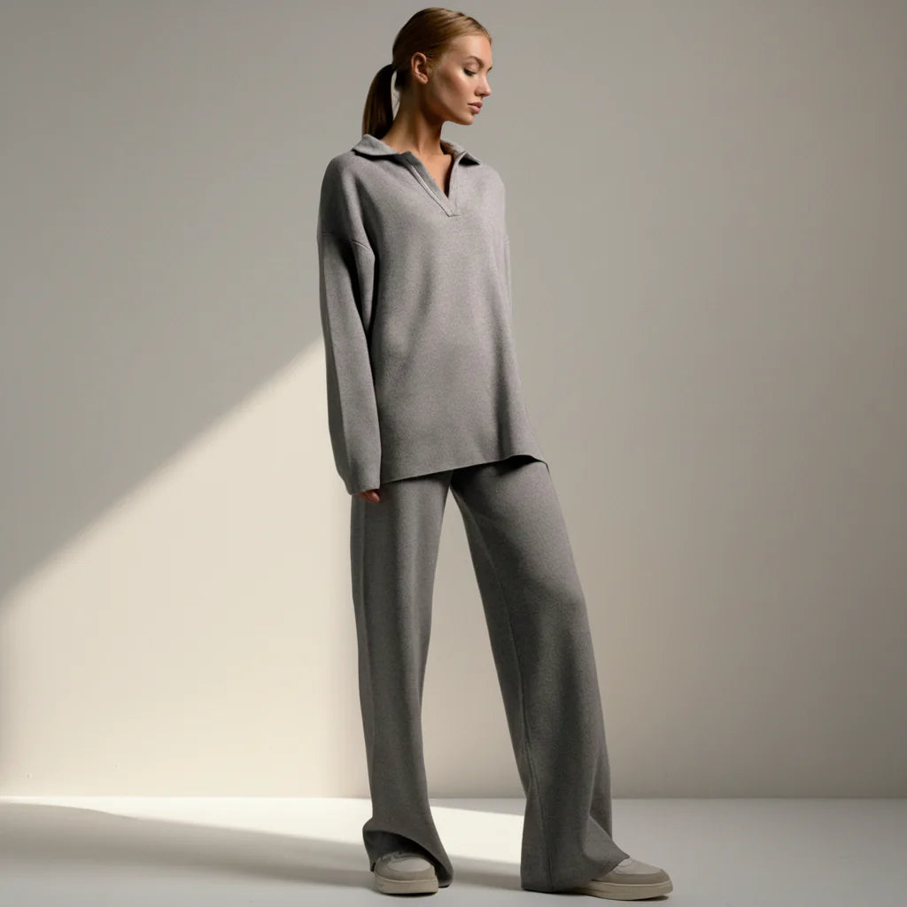 Woman wearing a gray outfit on a plain background