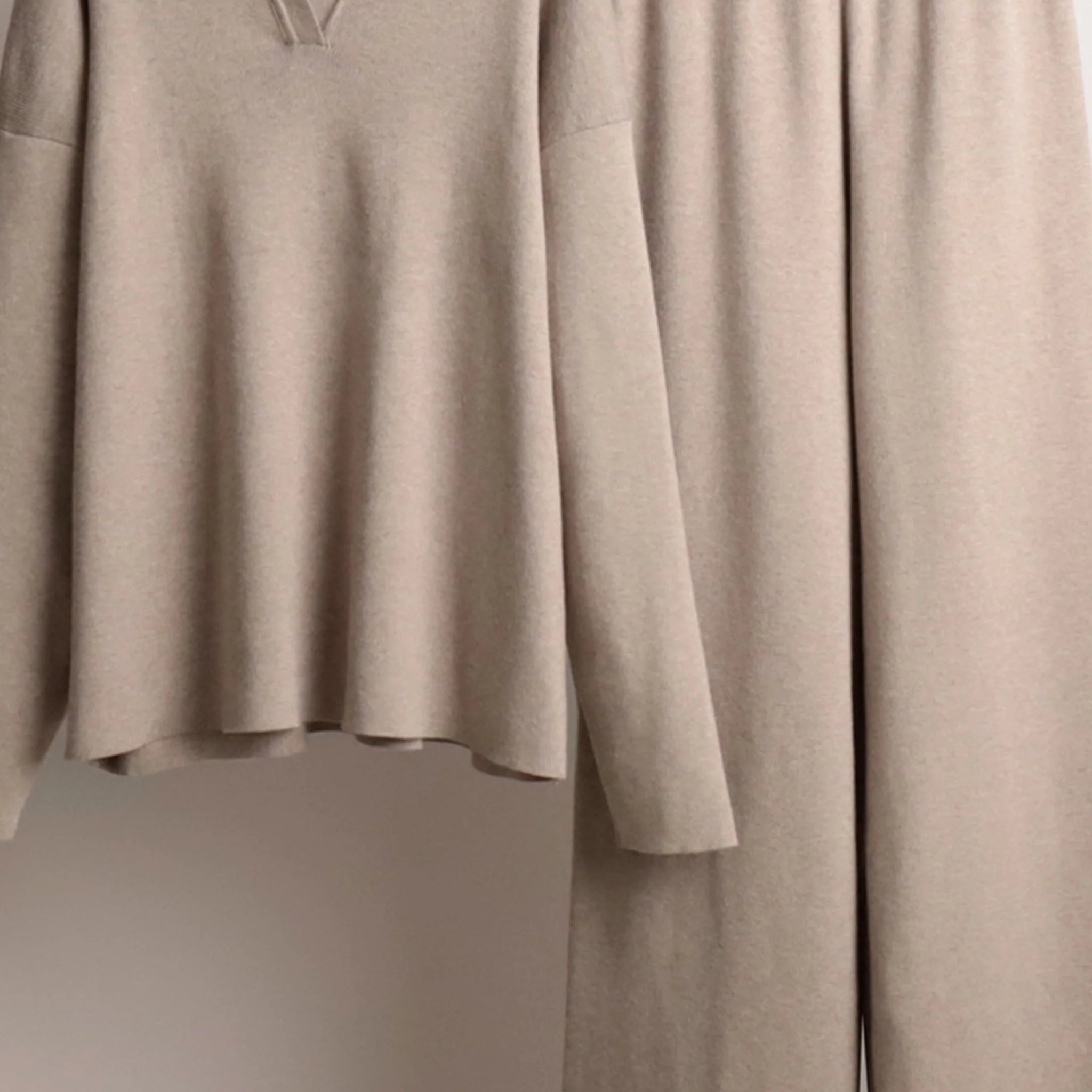 Beige dress on a mannequin against a neutral background