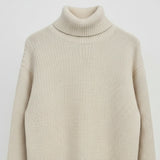 Beige turtleneck sweater on a light gray background
