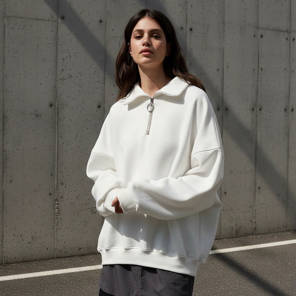 Woman wearing a white hoodie on a gray background