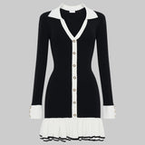 Black and white dress with a V-neckline and pleated skirt on a white background