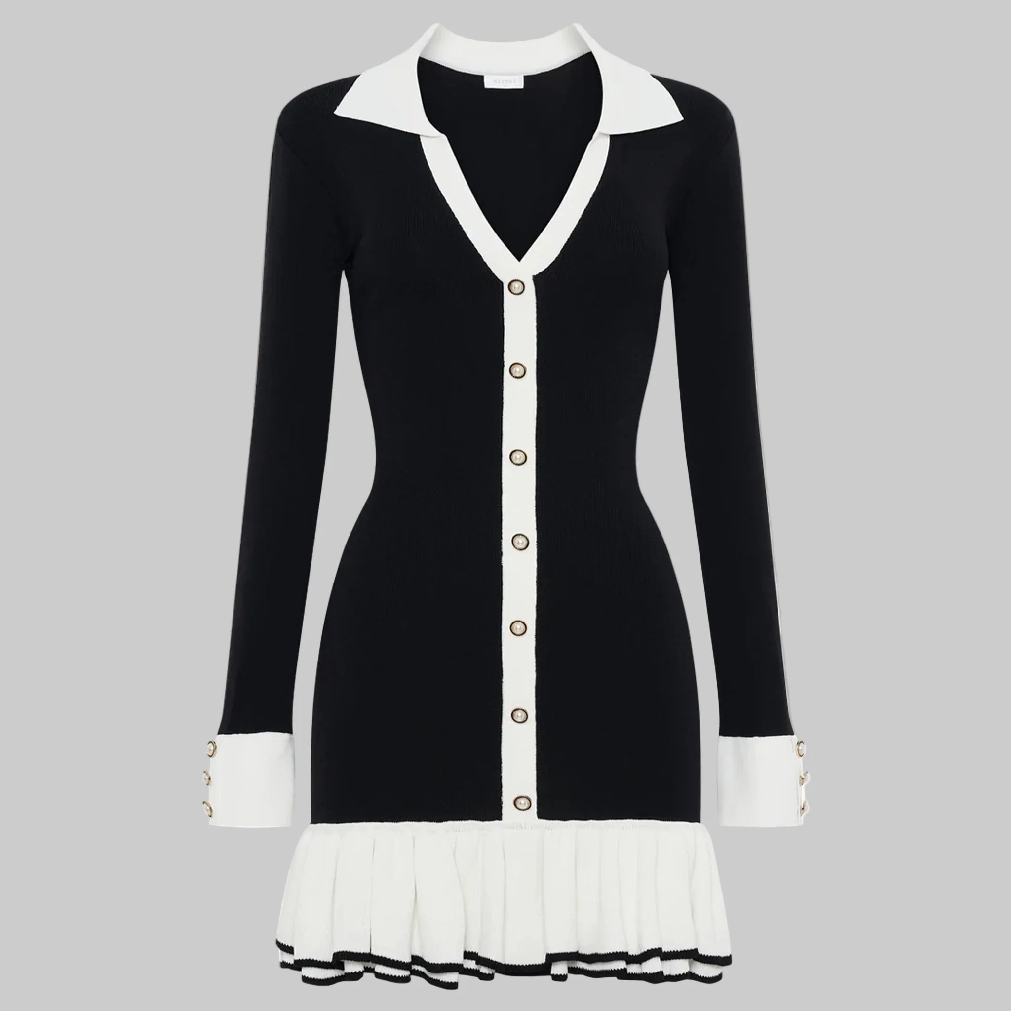 Black and white dress with a V-neckline and pleated skirt on a white background