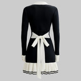 Black dress with white accents on a gray background