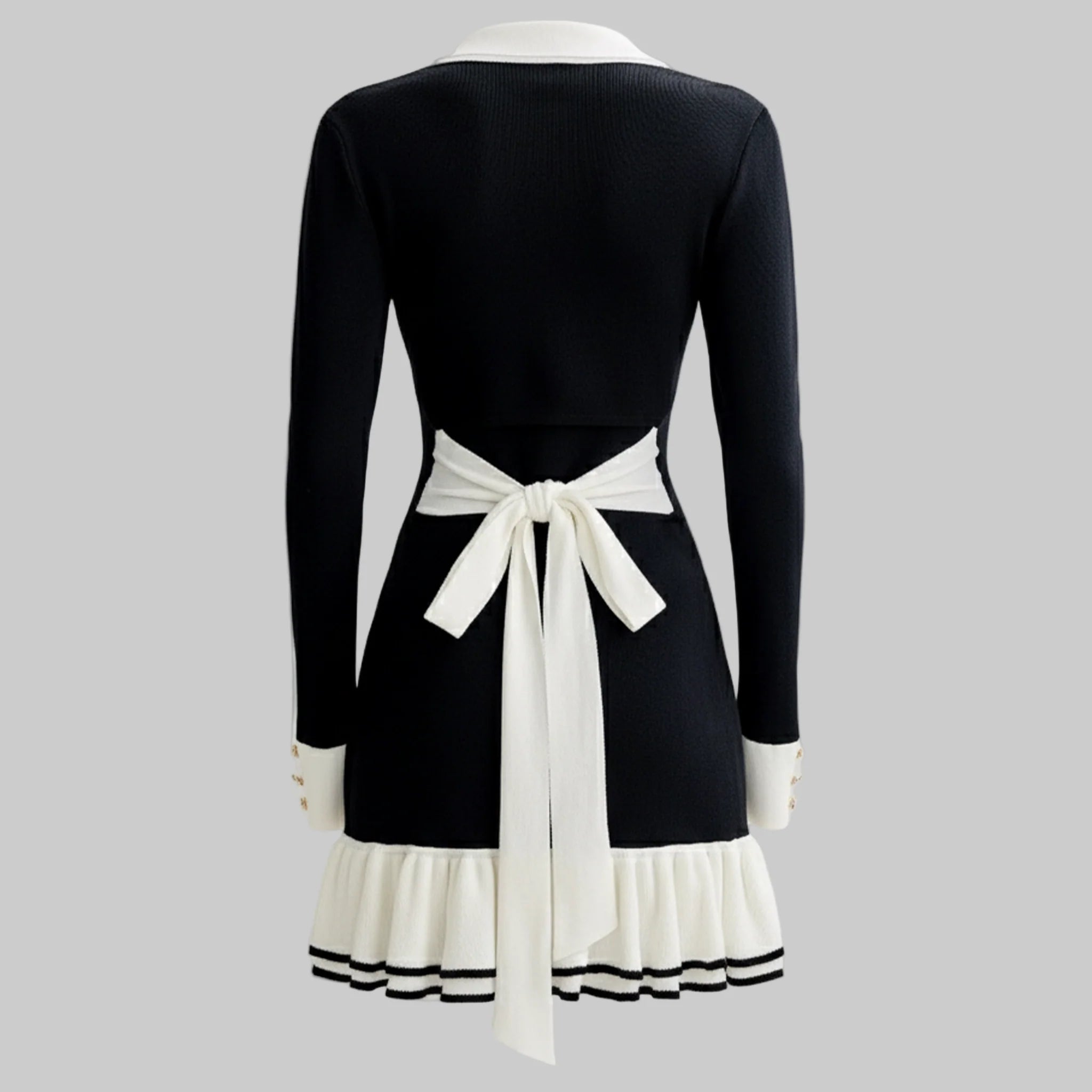 Black dress with white accents on a gray background