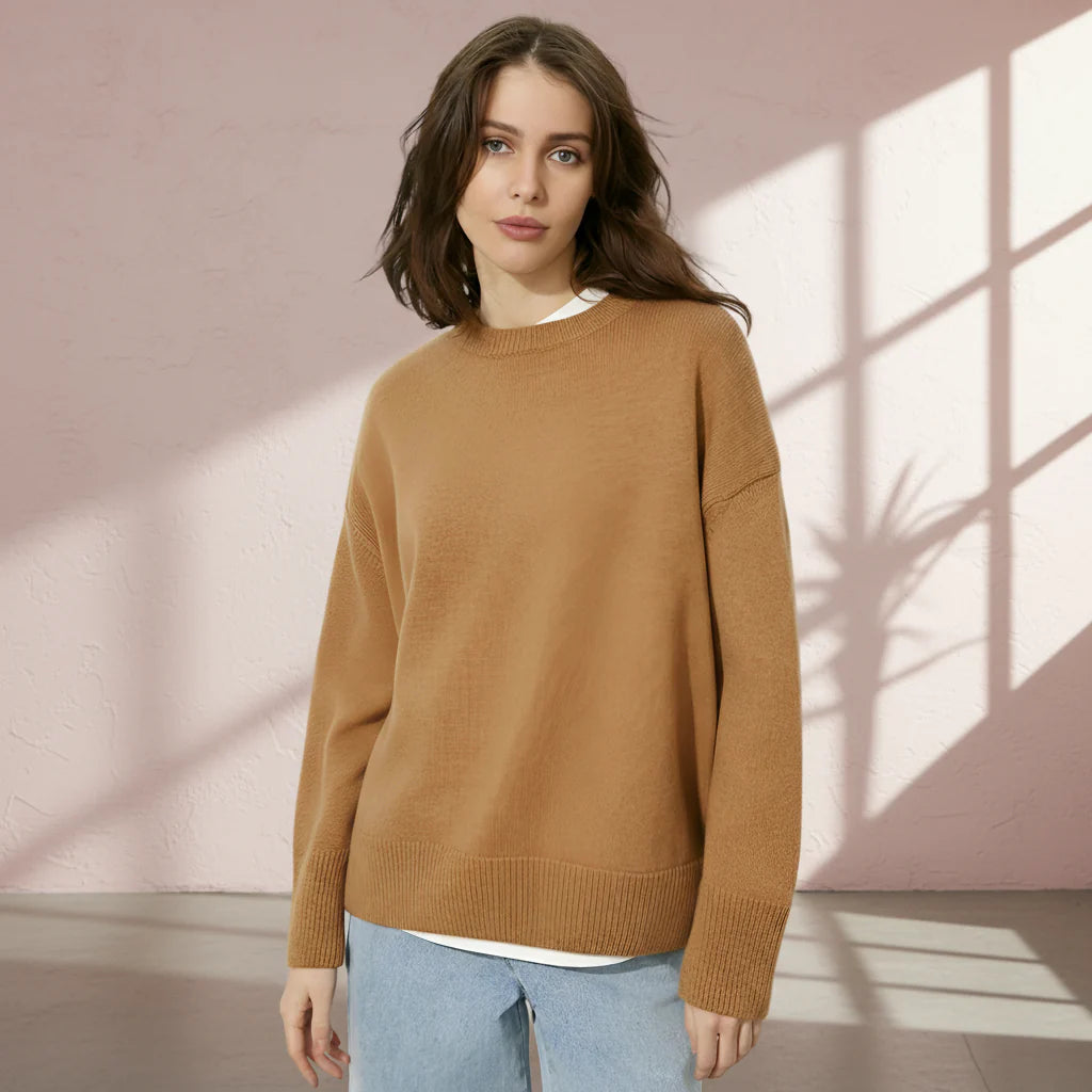 Woman wearing a brown sweater on a gray background