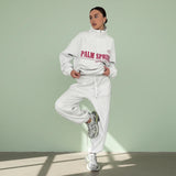 Person wearing a white hoodie with 'Palm Springs' text on a gray background