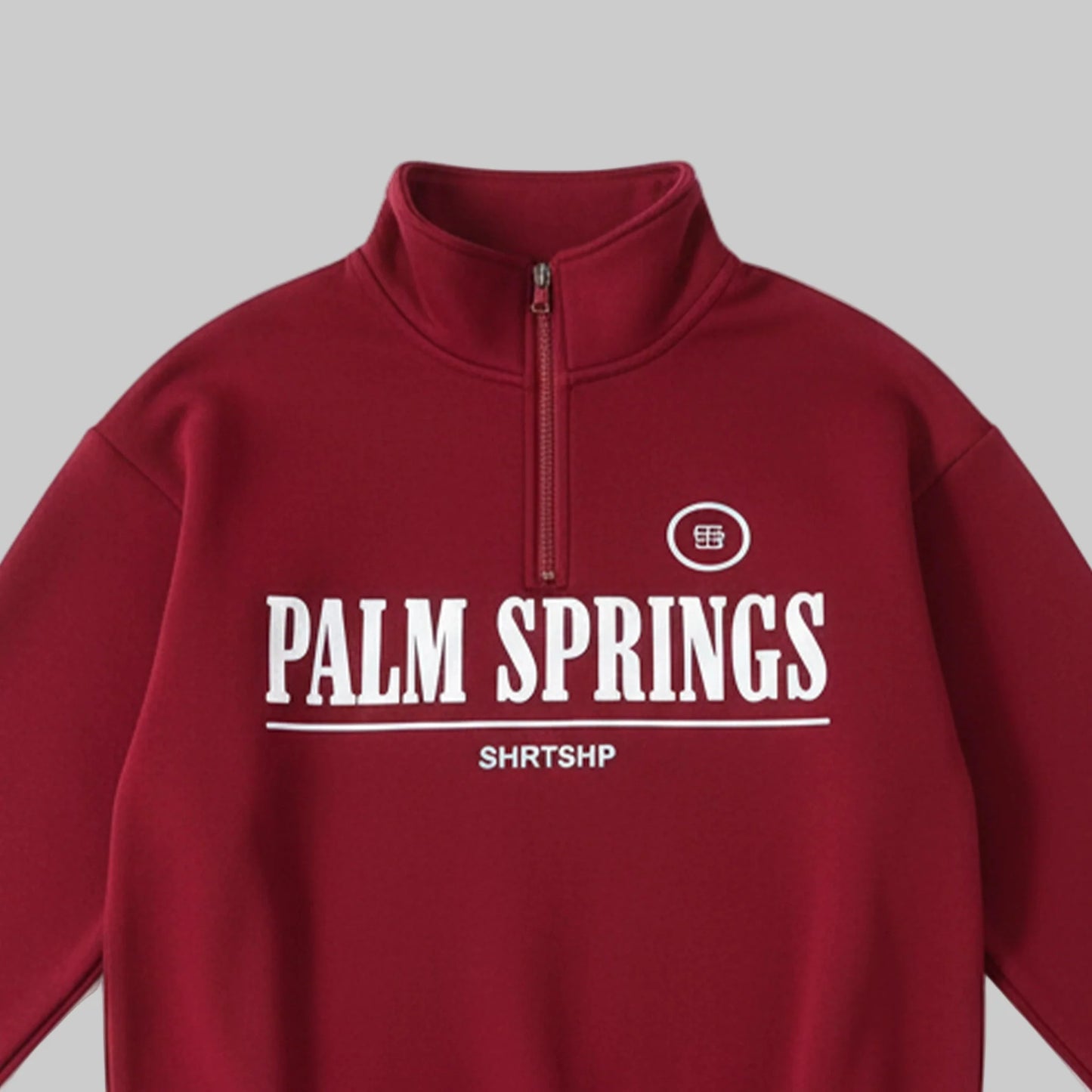 Red half-zip sweatshirt with 'Palm Springs' text on a white background