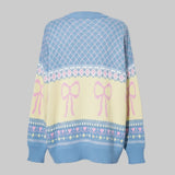 Sweater with pink bows and decorative patterns on a gray background