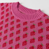 Pink knitted sweater with red strawberry pattern on a white background