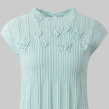 Light blue knitted dress with floral patterns on a white background