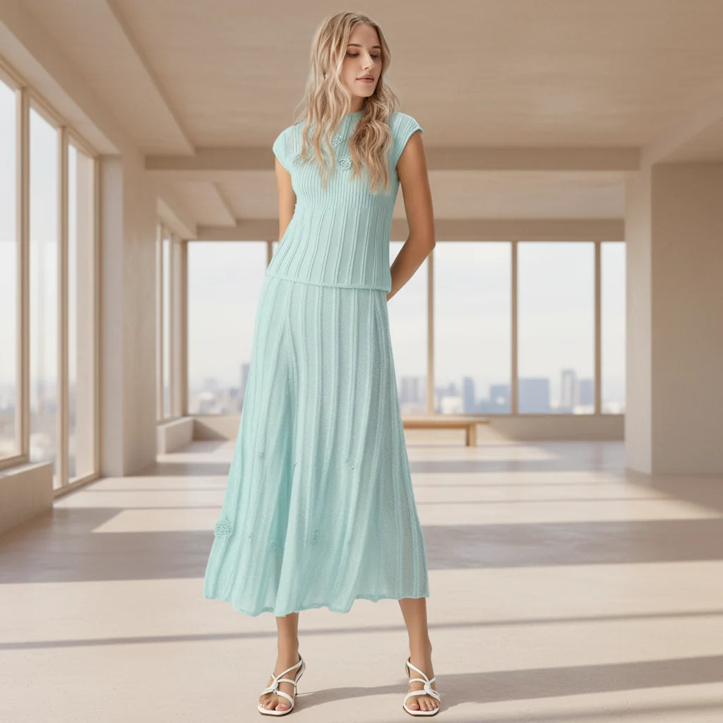 Woman wearing a light blue dress against a gray background