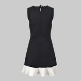 Black dress with white trim on a white background