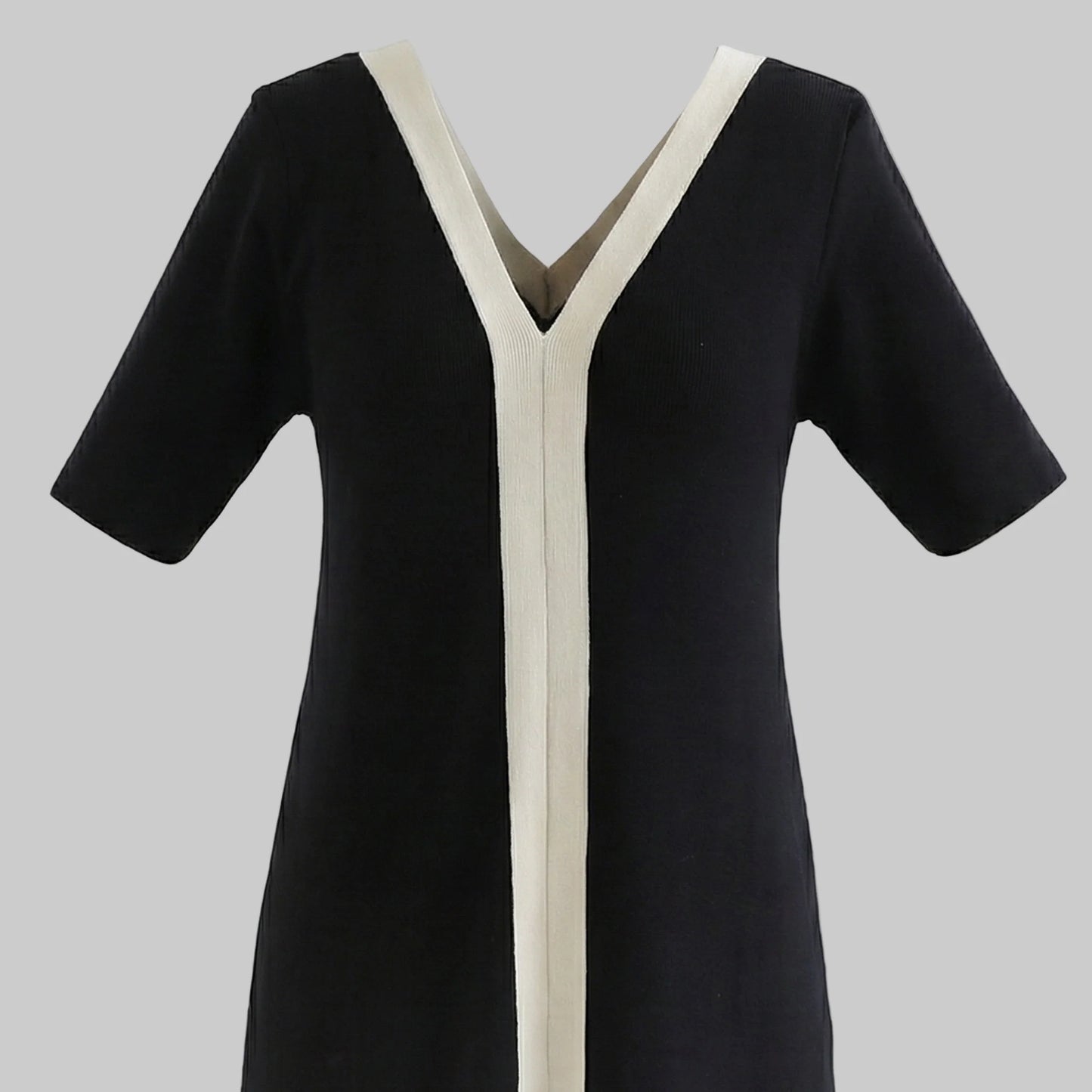 Black dress with white trim on a white background