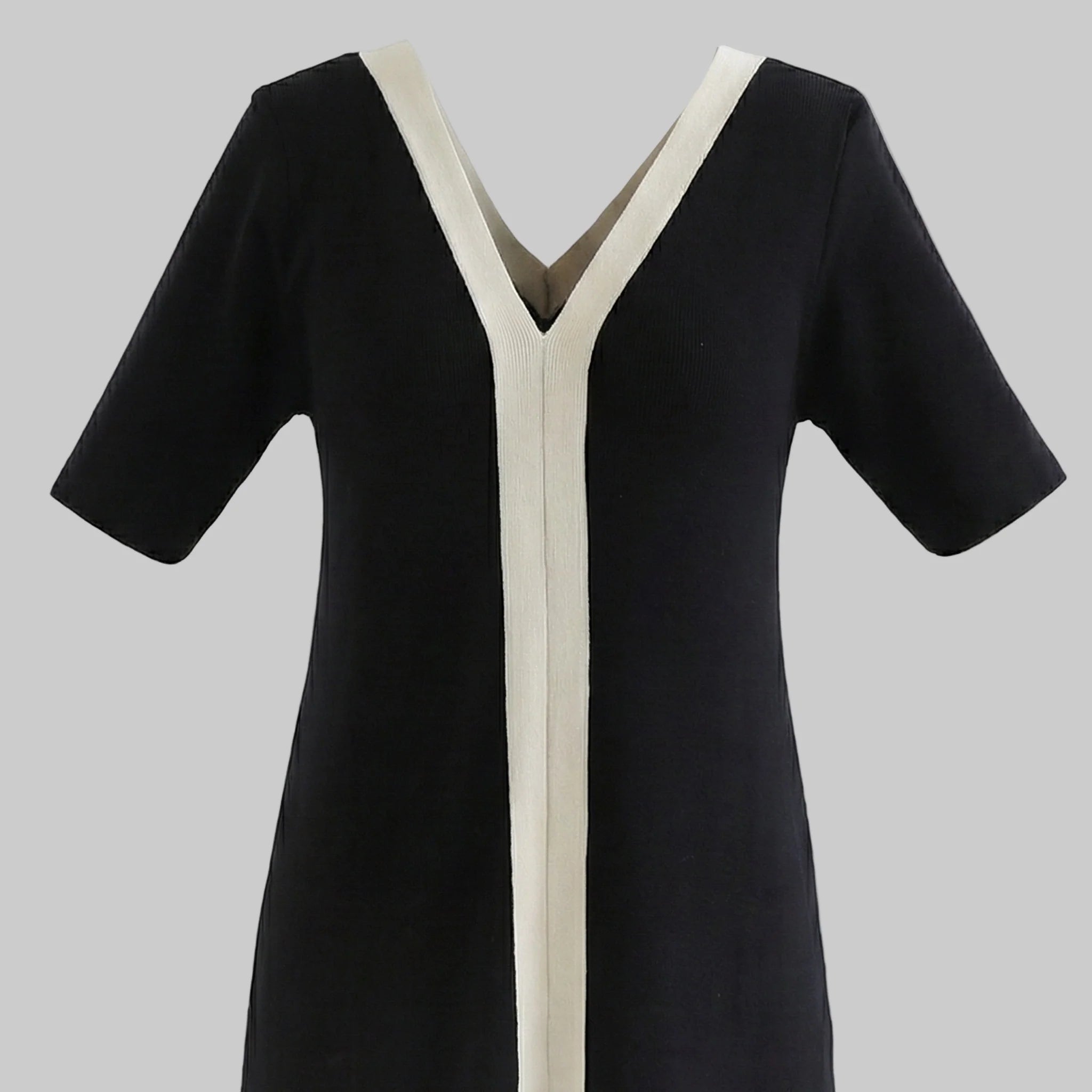 Black dress with white trim on a white background