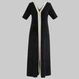 Black dress with a white stripe on a white background