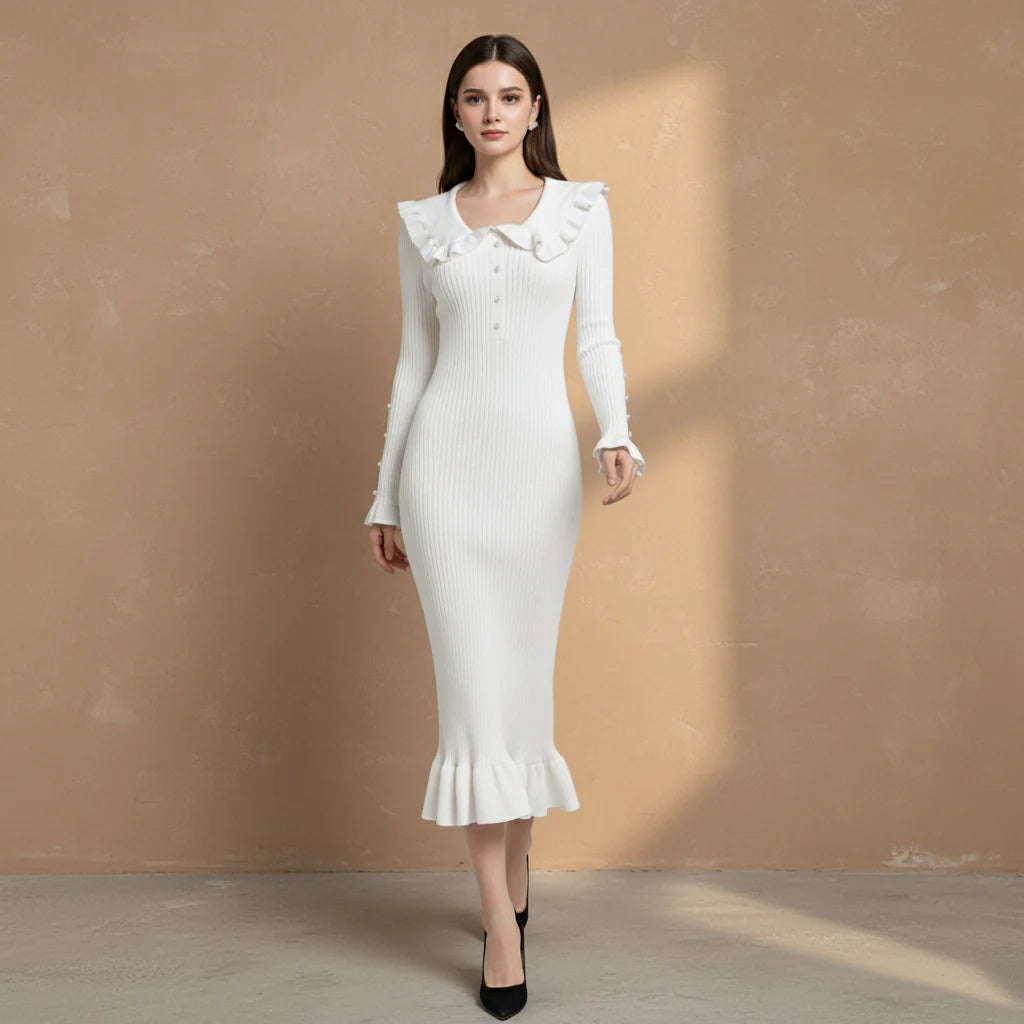 Woman wearing a white dress with ruffled details on a gray background